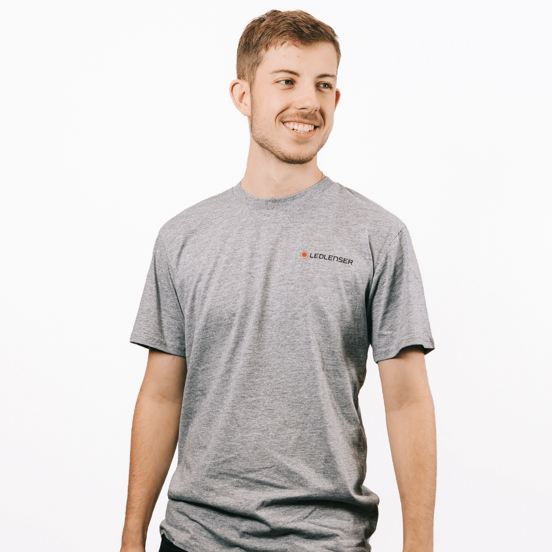 Mulga x Ledlenser Unisex Tee Aussie Animalia model wearing grey t shirt with Ledlenser logo on chest side view