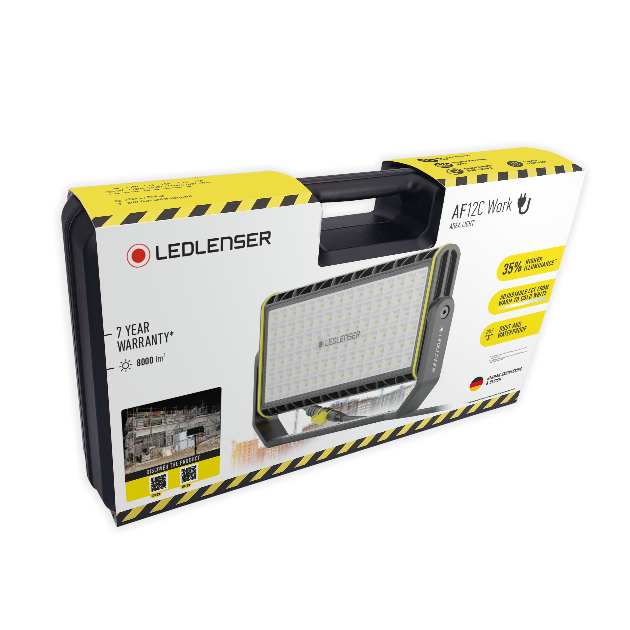 AF12C Work Floodlight shown in packaging featuring a compact mains operated LED work light with a carry handle and yellow black safety accents