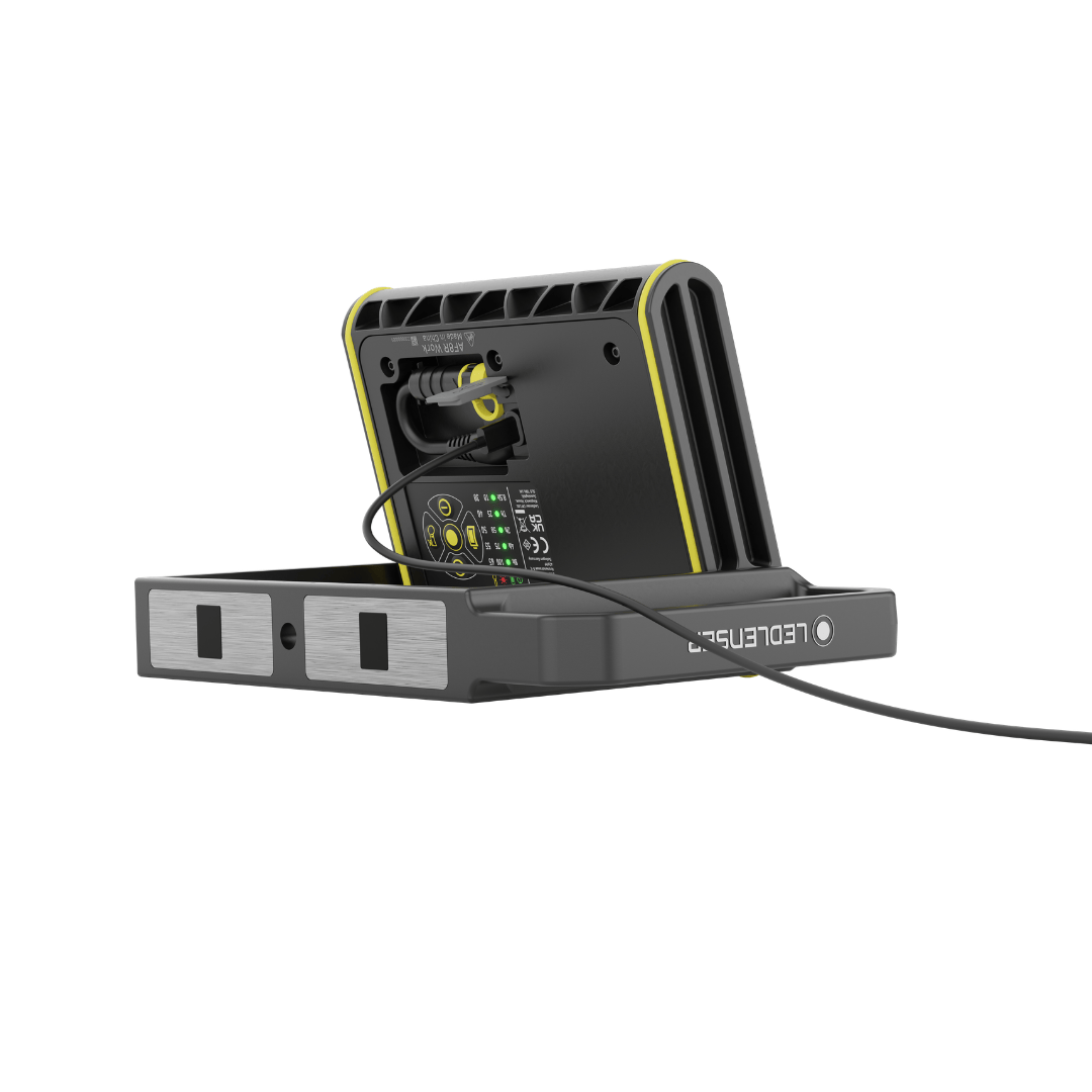 AF8R Work Floodlight on charging dock with rear control panel and LED indicators yellow and black rugged housing