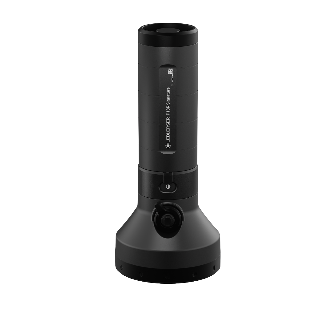 Ledlenser P18R Signature Torch standing upright on its charging base black cylindrical body with segmented grip and visible label