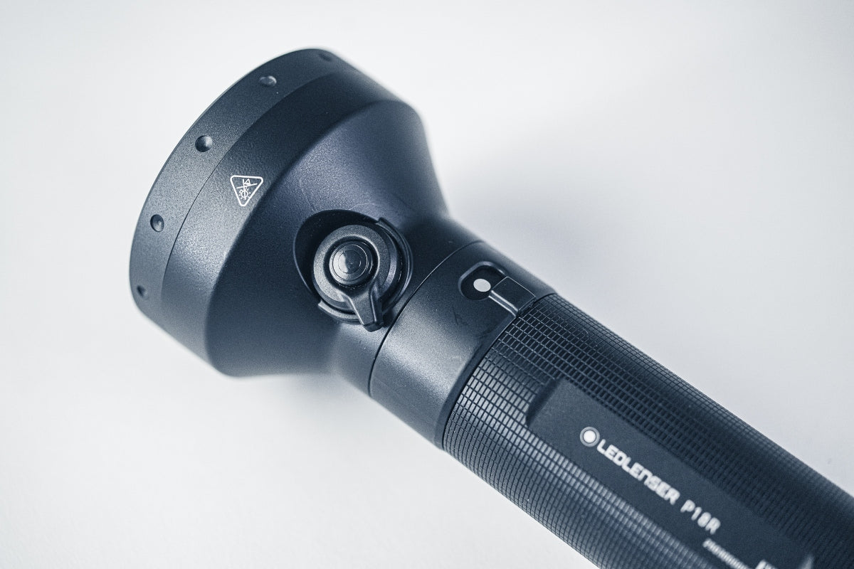 P18R Torch head and textured grip side view showing the adjustable head joint and Ledlenser logo