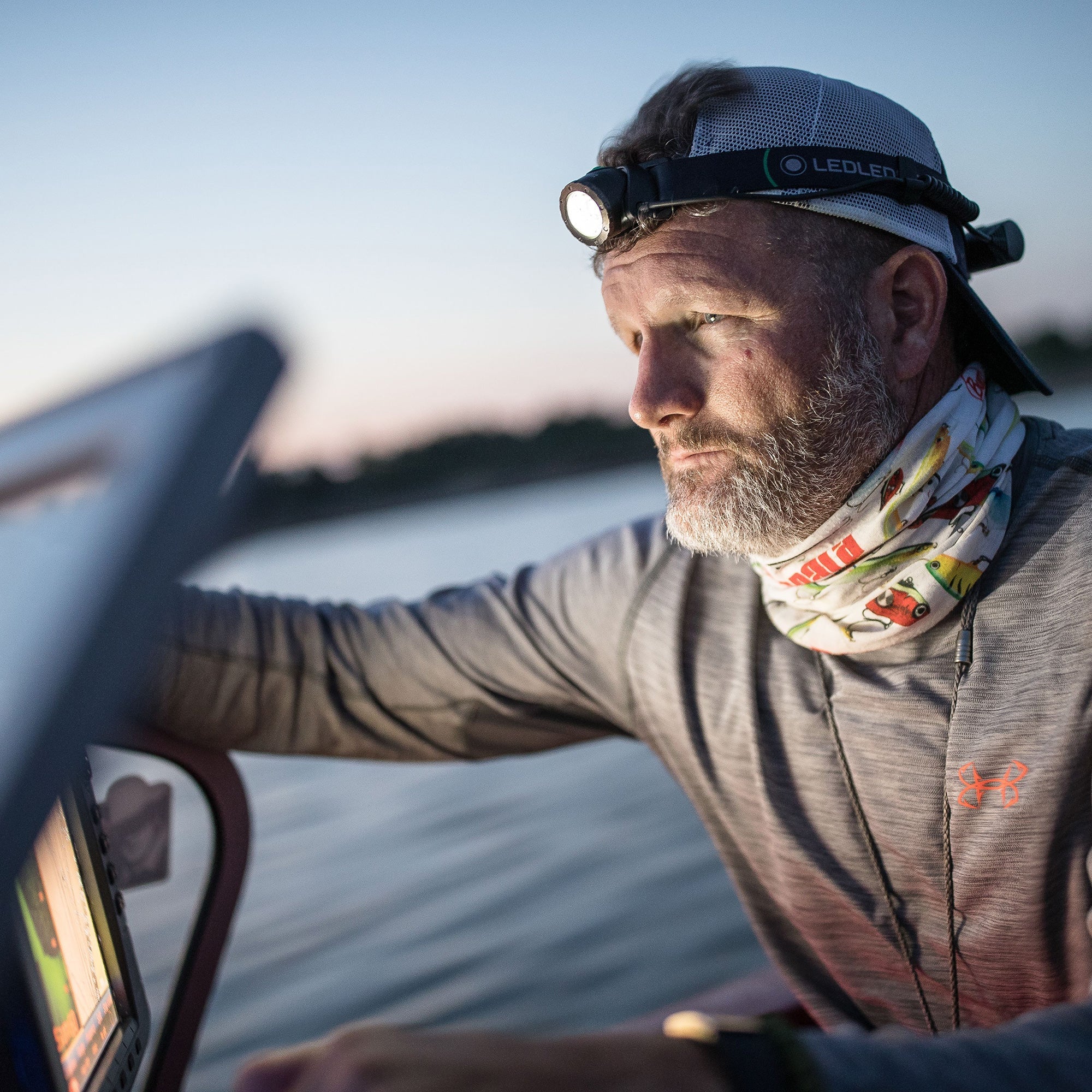 Ledlenser MH10 Headlamp worn on a man's head during dusk on a boat for hands free lighting