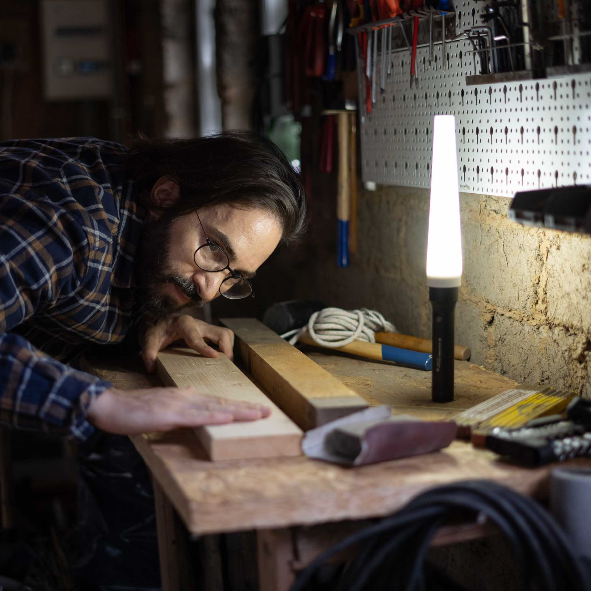 Signal Cone W 53mm Suits P17R Core Torch accessory shown beside a bright Ledlenser lamp as a craftsman works on wood
