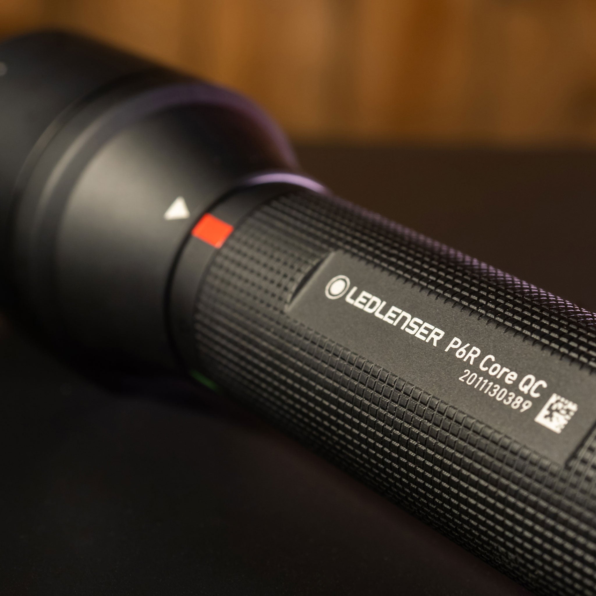 Ledlenser P6R Core QC torch close up of black textured body with branding and serial number visible