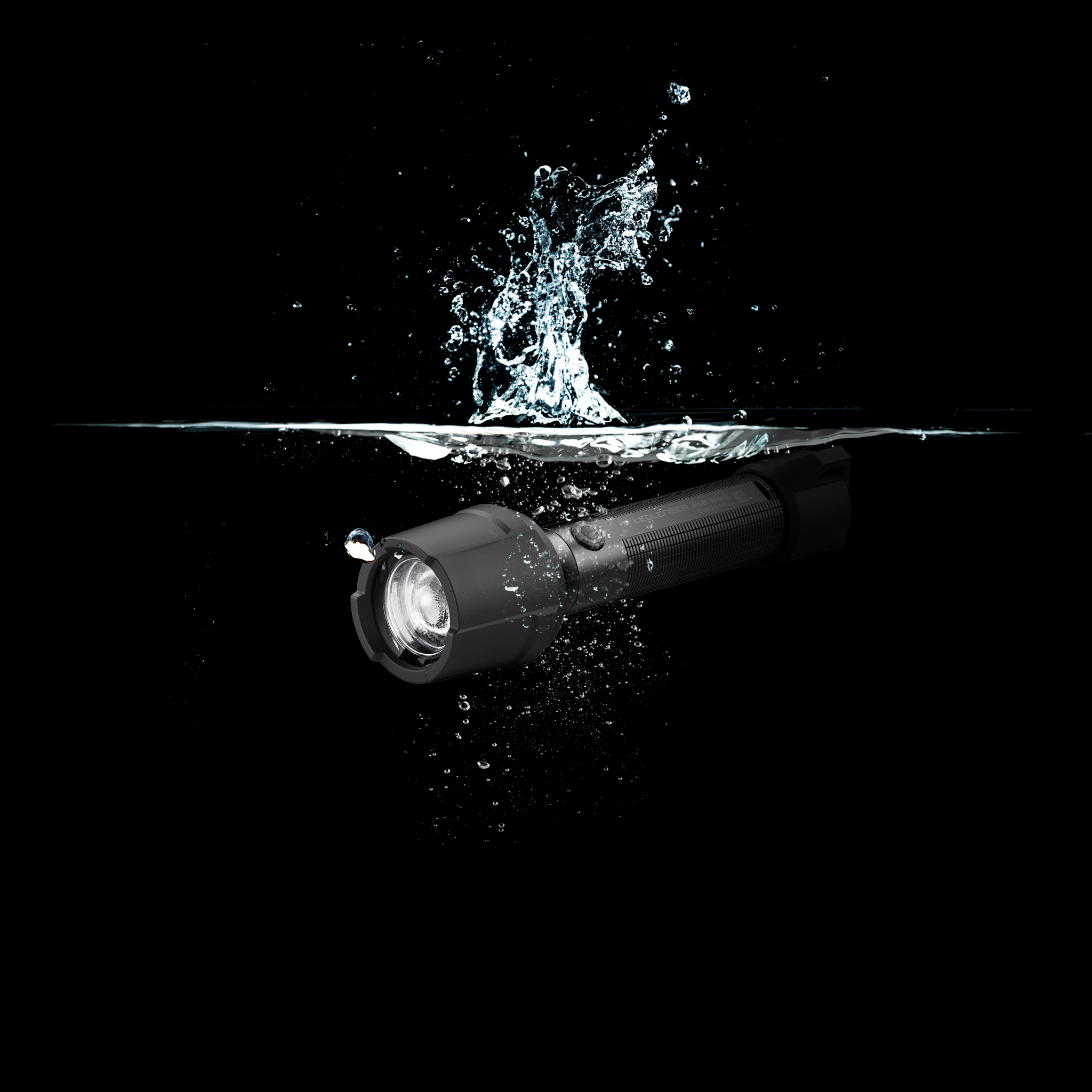 Ledlenser P6R Work Torch depicted submerged in water with a black cylindrical rechargeable flashlight front lens visible and textured grip
