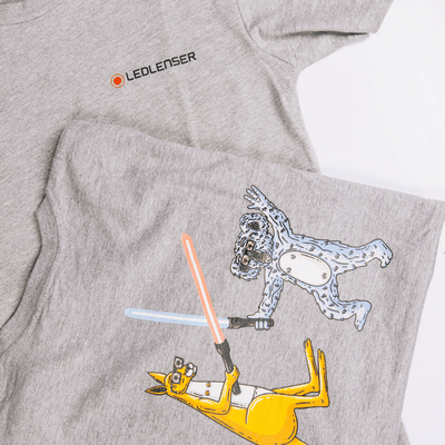Mulga x Ledlenser Unisex Tee Aussie Animalia grey t shirt featuring the Ledlenser logo and a cartoon koala and kangaroo with lightsabers in a dynamic scene