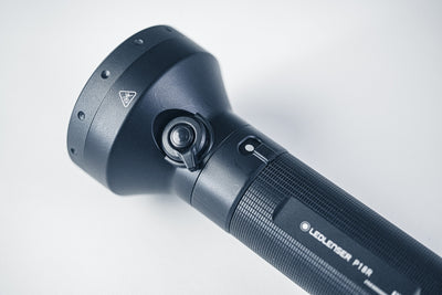 P18R Torch head and textured grip side view showing the adjustable head joint and Ledlenser logo