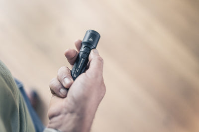 P5R Torch held in a hand close up of a compact Ledlenser rechargeable flashlight