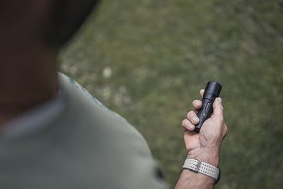 P7 Torch held in a right hand outdoors a compact black Ledlenser flashlight with textured grip in use