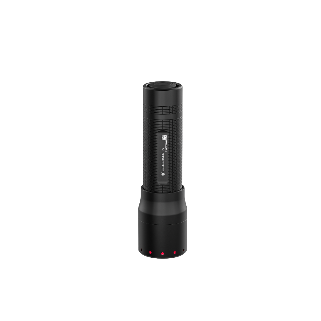 Ledlenser P7 Torch standing upright in dark with textured black body and base dock; red status lights visible