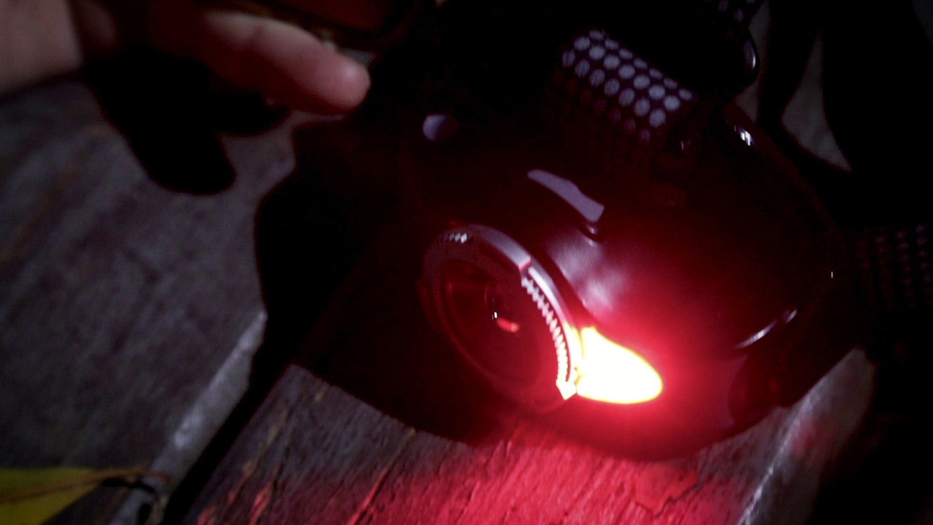 MH11 Blue Outdoor Headlamp worn on the head with red illumination in a dark outdoor setting