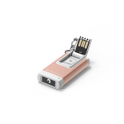 Ledlenser K4R Keychain Light with rose gold body white accents USB recharge port and keyring attachment shown on a white surface
