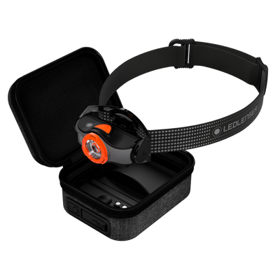 Ledlenser MH8 Powercase Combo headlamp with charging case black adjustable headband with orange bezel shown resting on open case