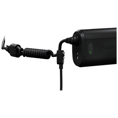 Ledlenser H15R Core Headlamp connected to a rechargeable battery pack with a coiled charging cable side view