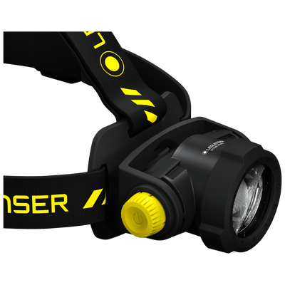 H15R Work Headlamp angled side view showing black headband with yellow accents yellow dial and rugged front lens