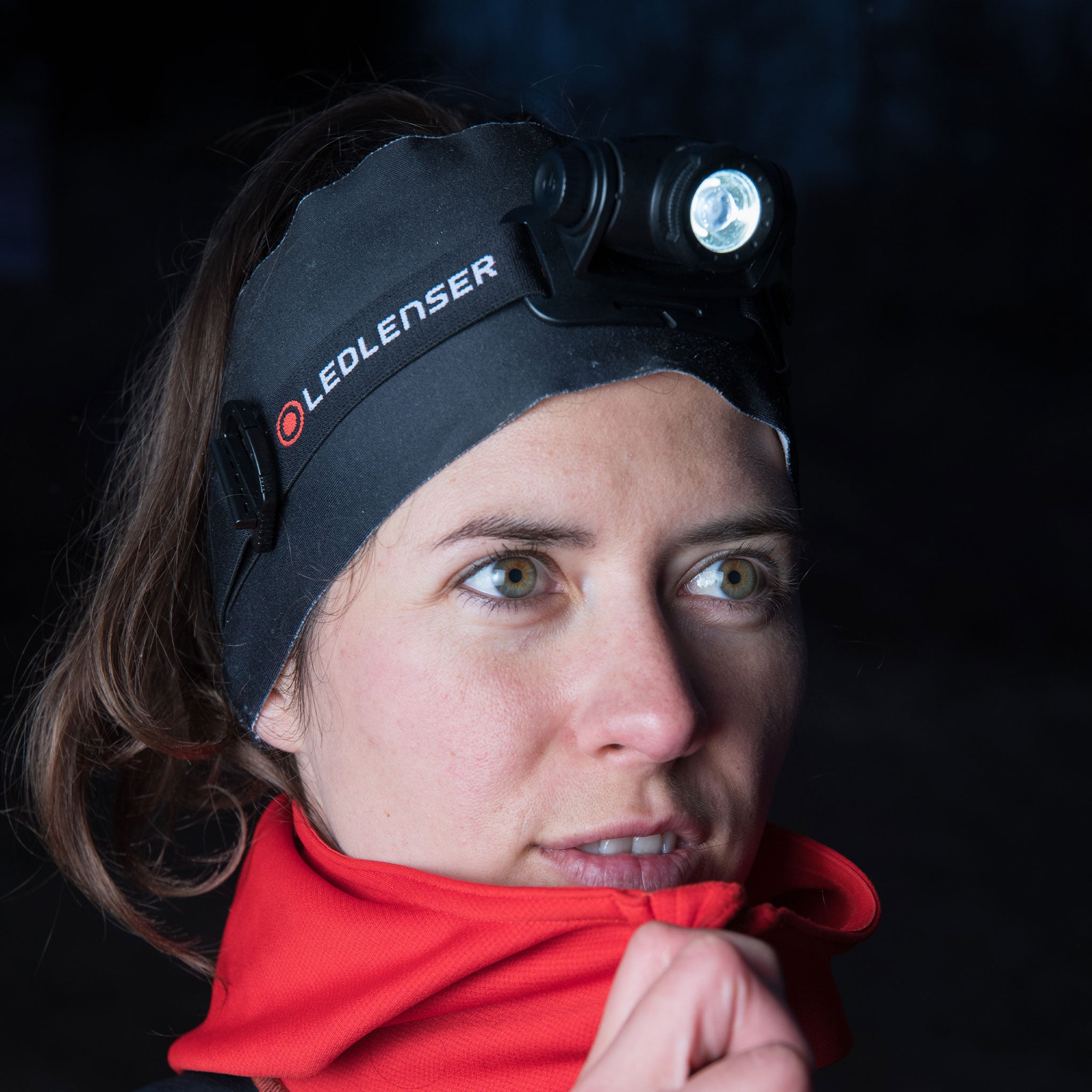 H5 Core Headlamp worn on a woman’s head; black Ledlenser headband with logo; light module oriented forward