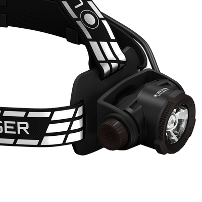 Ledlenser H7R Signature Headlamp mounted on a black headband with reflective white stripes front LED module visible and adjustable dial on the side