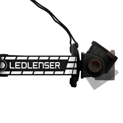 Ledlenser H7R Signature headlamp with black and white striped strap mounted on side battery housing and adjustable dial angled view