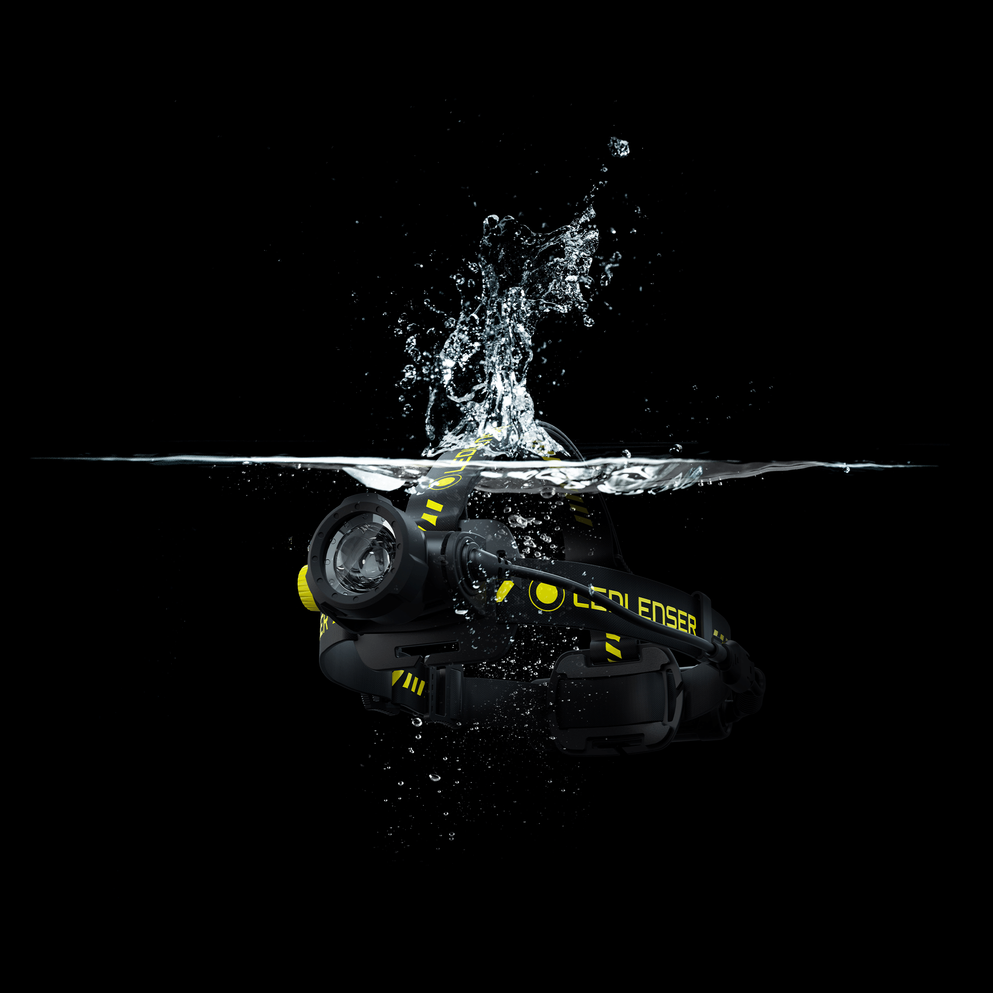 Ledlenser H7R Work Headlamp submerged in splash; black body with yellow branding and adjustable head strap