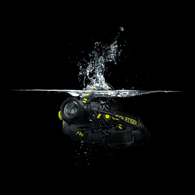 Ledlenser H7R Work Headlamp submerged in splash; black body with yellow branding and adjustable head strap