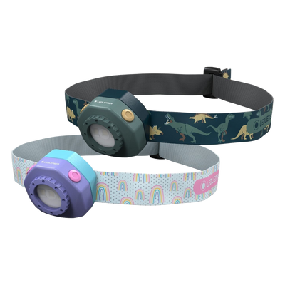 Kidled4R Headlamp by Ledlenser showing two color variants with adjustable headbands dark green dinosaur pattern strap and purple with rainbow pattern headband