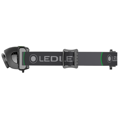 MH6 Headlamp worn on a black adjustable headband with front light housing and green accent branding on the strap