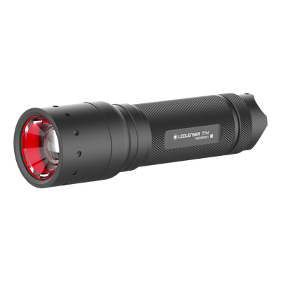 Ledlenser T7M Torch shown in side angle view with black textured body and red front bezel