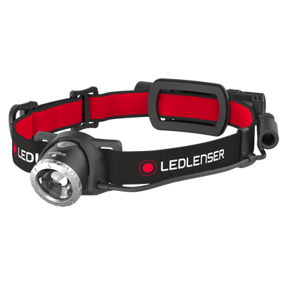 Ledlenser H8R Headlamp with red and black adjustable head strap and front LED lens housing oriented to the left