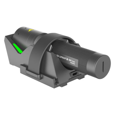 Ledlenser i9R Iron 2 rechargeable torch shown mounted in a grey charging cradle with a green status light