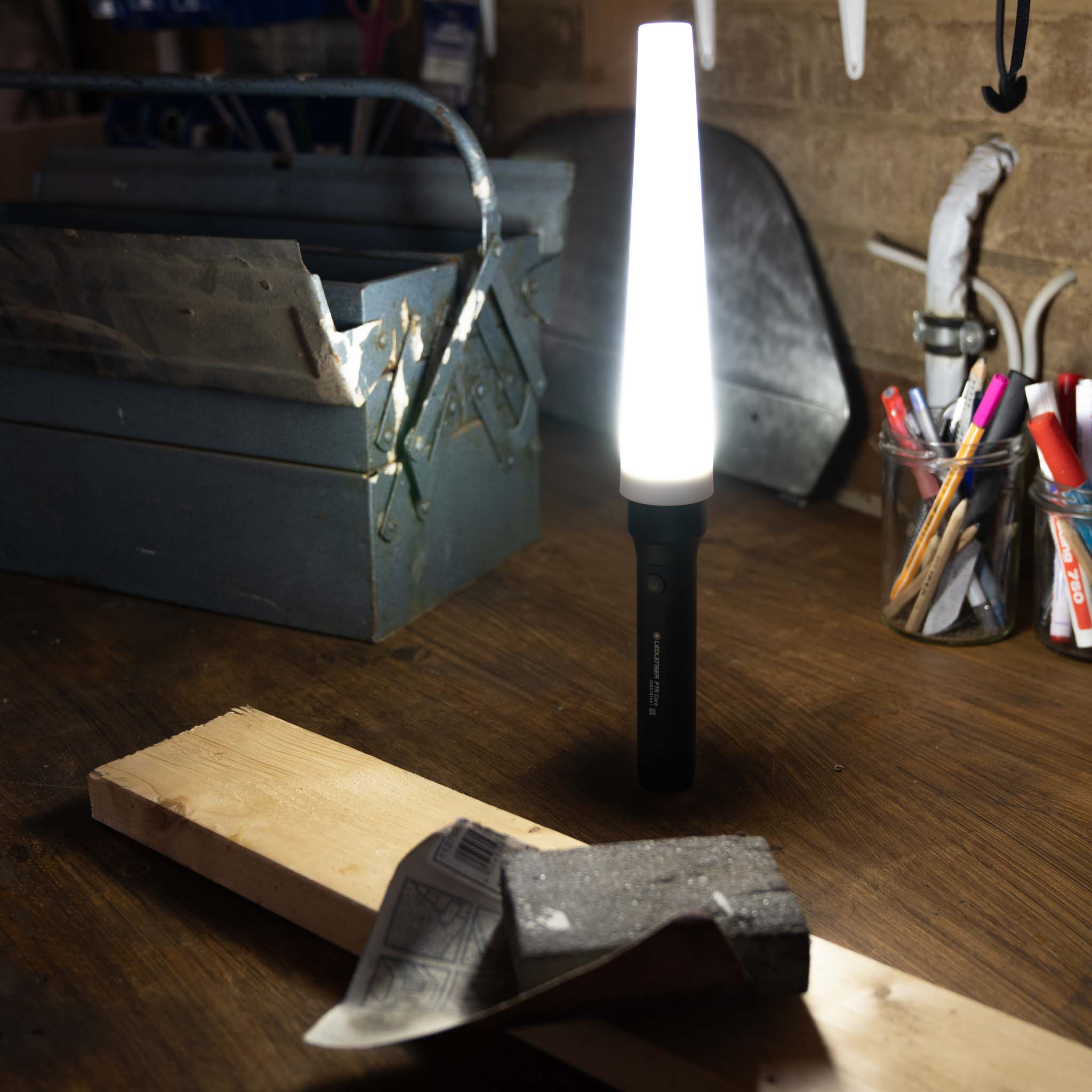 Signal Cone W 42mm on a Ledlenser torch illuminated upright on a wood workbench in a workshop