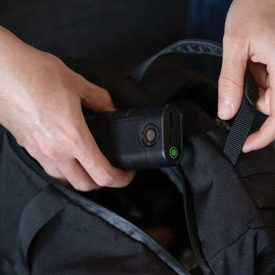 Ledlenser Flex10 Powerbank being placed into a backpack showing USB ports and a green power button