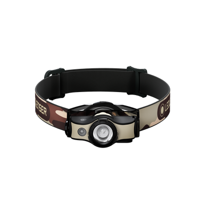 Ledlenser MH4 Powercase Combo headlamp with charging case front view showing camo headband and beige housing circular LED lens and side control button