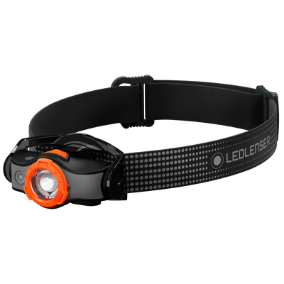 MH5 Outdoor Headlamp with black adjustable head strap and orange bezel shown worn on the head