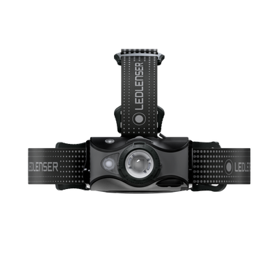 MH7 Outdoor Headlamp mounted on a vertical support with cross strap showing the front LED bezel and dark grey housing