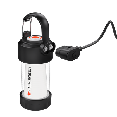 Ledlenser ML4 Warm Light Lantern with black top and base clear body red button ring and attached charging cable in front view