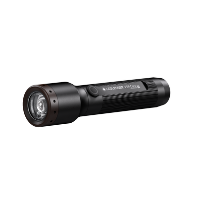 Ledlenser P5R Core Torch lying on a white background black compact rechargeable torch with textured grip and front lens
