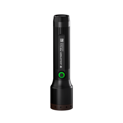 Ledlenser P5R Core Torch standing upright; black cylindrical flashlight with textured grip green ring around the power button and brown base