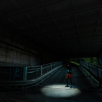 Ledlenser P7R Signature torch illuminating a dark underpass with a person standing in the light beam