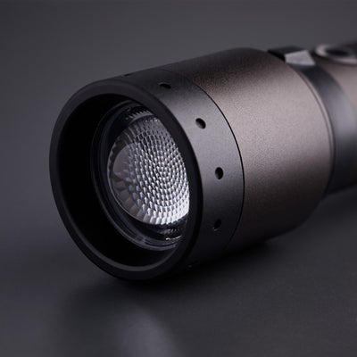 P7R Signature Torch close up of front lens and textured reflector on black metallic body