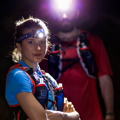 Ledlenser SEO7R Headlamp worn by climber with head strap in a dark environment compact rechargeable headlamp in use