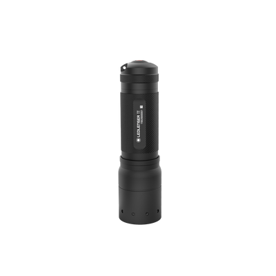Tac Torch TT Ledlenser handheld flashlight with black textured body upright red beam visible