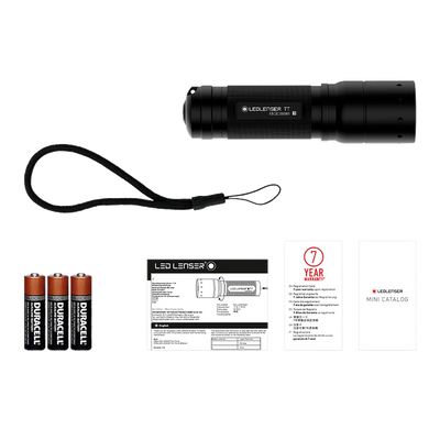 Tac Torch TT black compact flashlight with included lanyard three Duracell batteries and accompanying manuals and catalog