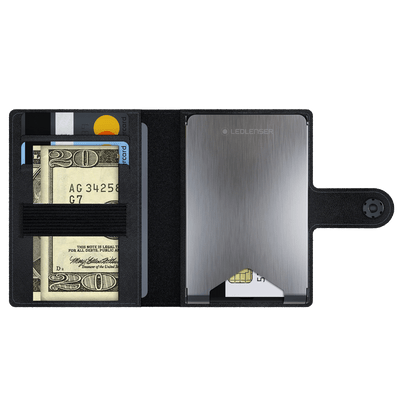Lite Wallet® open view showing card slots with cards and cash on left and a brushed metal Ledlenser case on the right